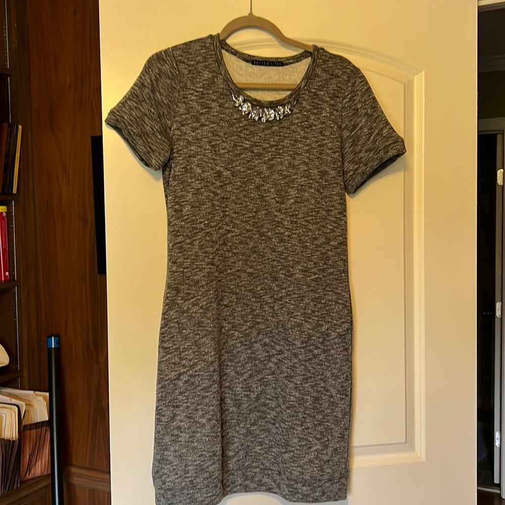 Knit dress with pockets and jewel embellishment.